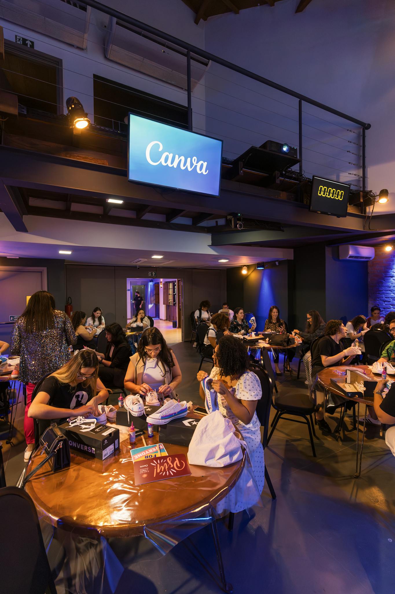 A lively social event at a Canva venue with people engaging in activities.