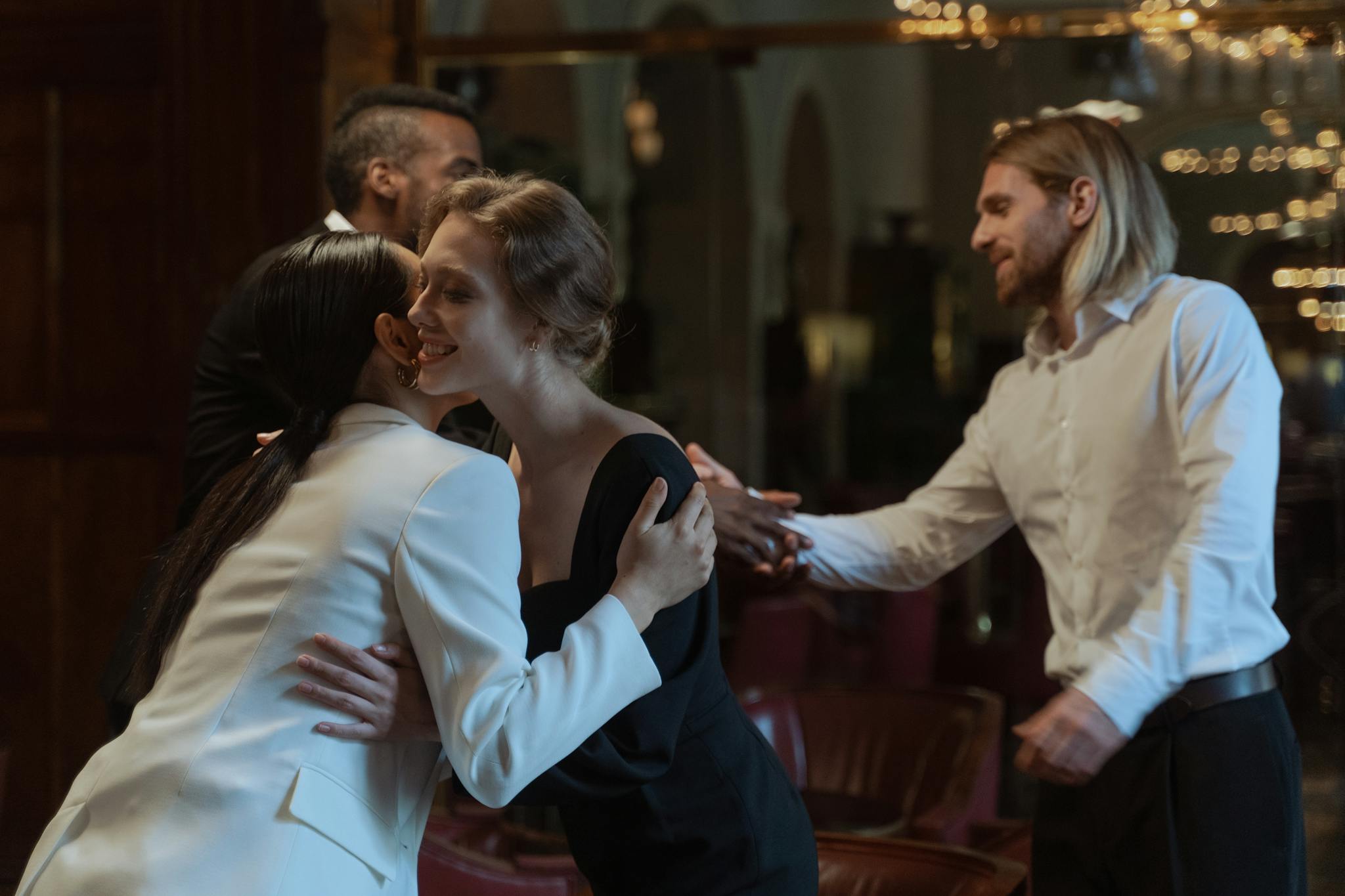 Business professionals exchanging greetings during a formal meeting indoors.